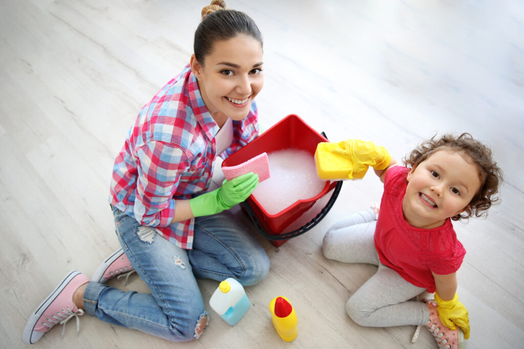 Happy family having fun and cleaning home